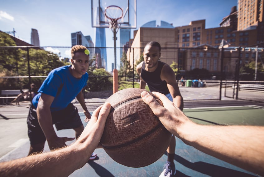 Two Street Basketball Players Playing Hard on the Court